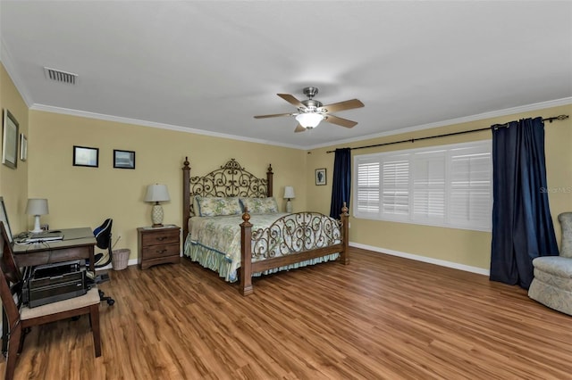 bedroom with hardwood / wood-style flooring, ceiling fan, and ornamental molding