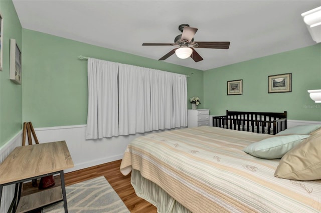 bedroom with hardwood / wood-style floors and ceiling fan