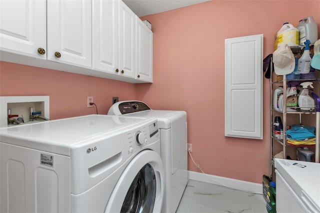 washroom featuring washer and dryer and cabinets