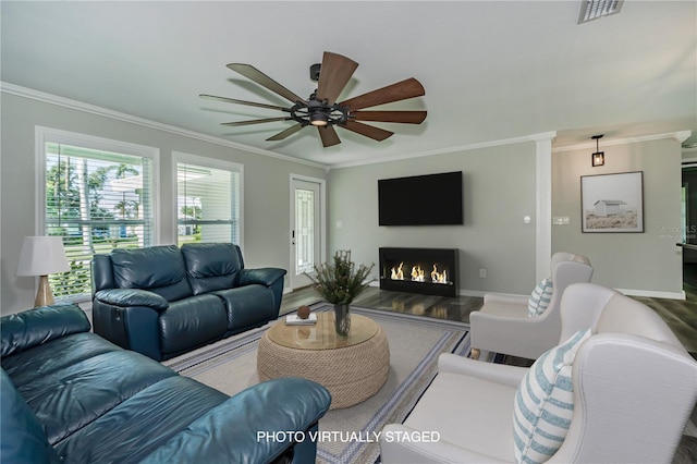 living room with hardwood / wood-style floors, ceiling fan, and crown molding