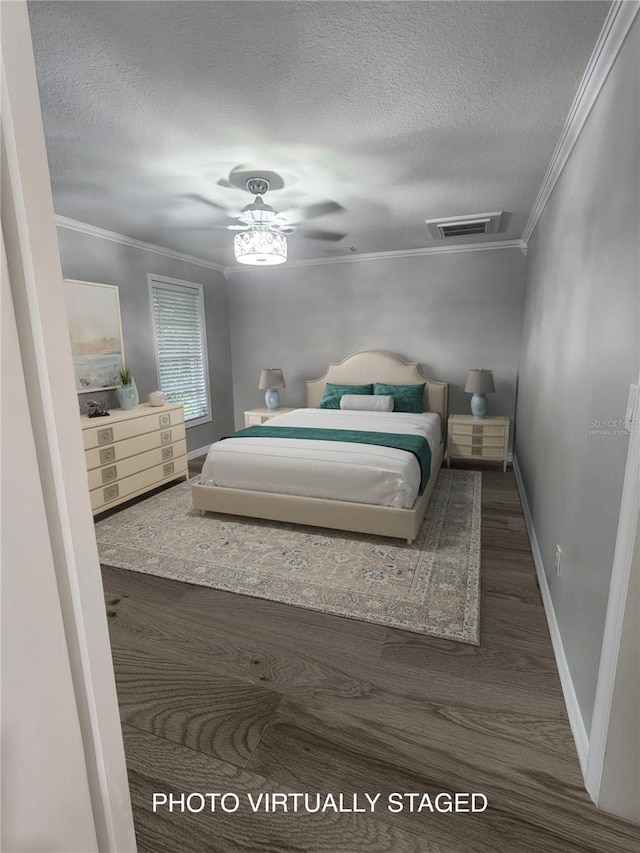 bedroom with ceiling fan, dark wood-type flooring, a textured ceiling, and ornamental molding