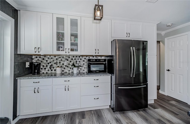 kitchen featuring light stone countertops, stainless steel fridge, ornamental molding, dark wood-type flooring, and white cabinetry