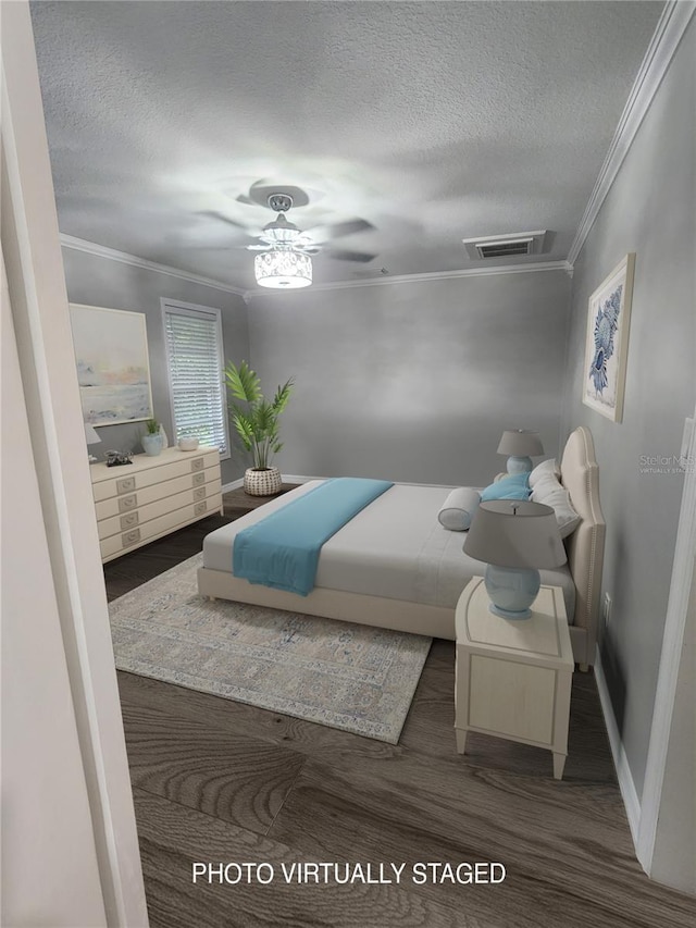 bedroom featuring a textured ceiling, dark hardwood / wood-style floors, ceiling fan, and ornamental molding