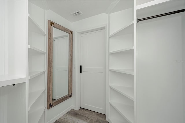 spacious closet featuring light hardwood / wood-style floors