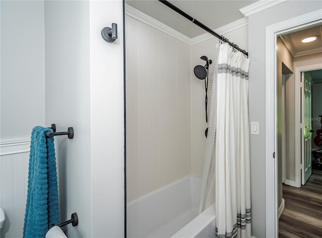 bathroom with hardwood / wood-style flooring, shower / bath combination with curtain, and ornamental molding