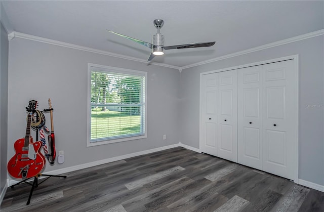 unfurnished bedroom with dark hardwood / wood-style flooring, a closet, ceiling fan, and ornamental molding