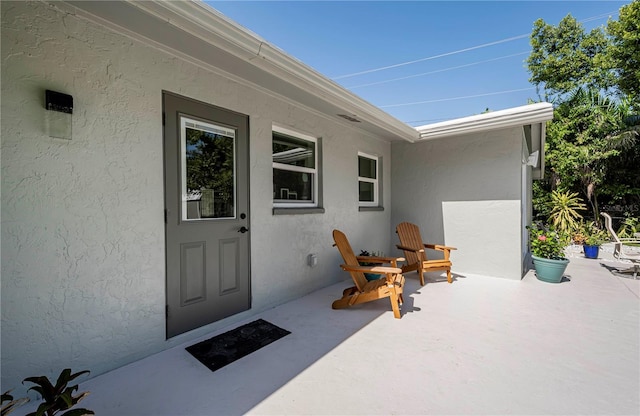 doorway to property featuring a patio area