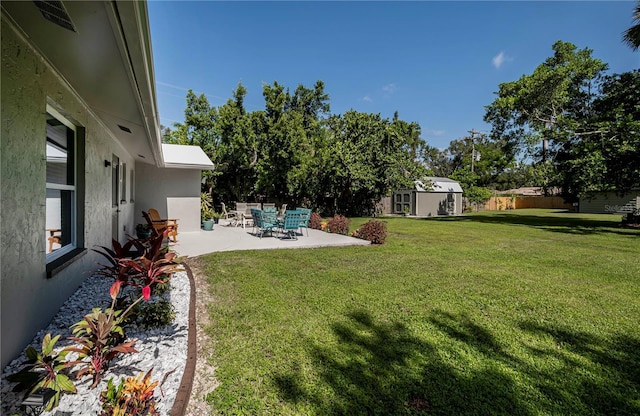 view of yard featuring a patio area and a storage shed