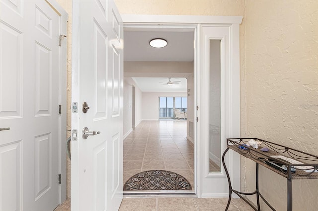 hallway featuring light tile patterned floors