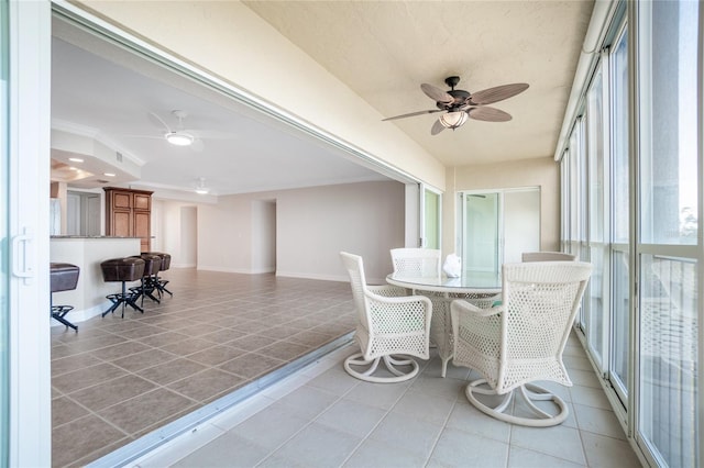 sunroom / solarium featuring ceiling fan