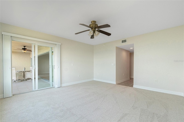 carpeted spare room with ceiling fan