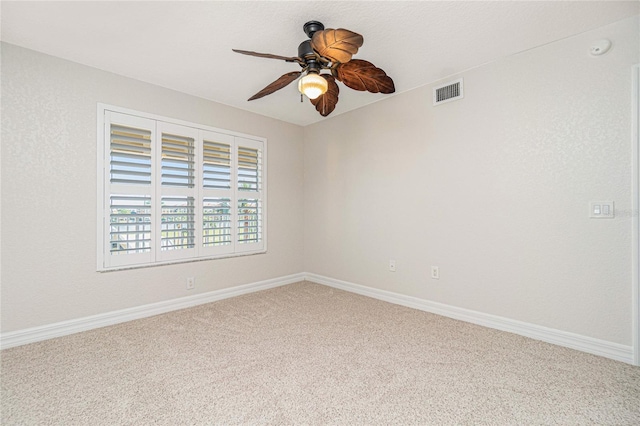 carpeted spare room featuring ceiling fan