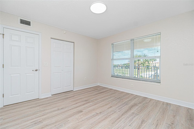 unfurnished bedroom featuring light hardwood / wood-style floors