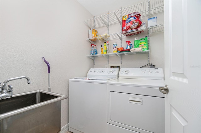 washroom featuring washer and dryer and sink