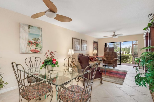 dining space with ceiling fan and light tile patterned floors