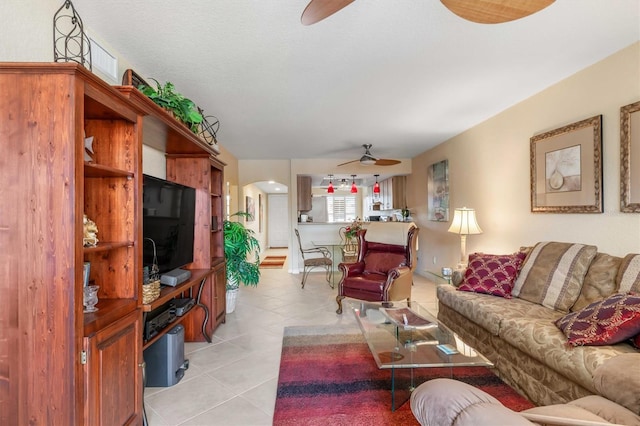 living room with ceiling fan and light tile patterned floors