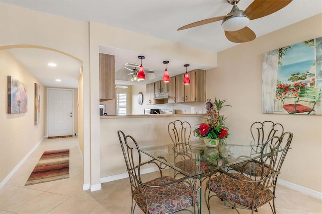 tiled dining area featuring ceiling fan