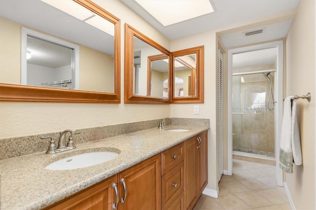 bathroom featuring walk in shower, vanity, and tile patterned flooring