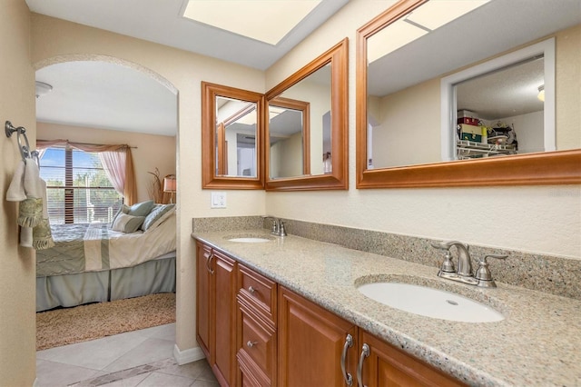 bathroom featuring tile patterned flooring and vanity