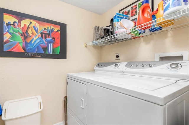 clothes washing area featuring separate washer and dryer