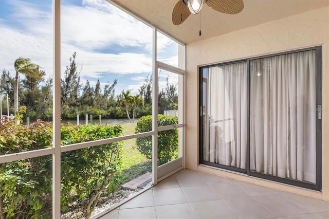 unfurnished sunroom with ceiling fan and plenty of natural light