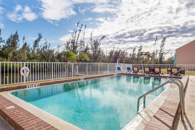 view of swimming pool featuring a water view