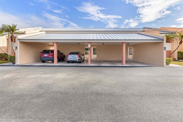 view of vehicle parking with a carport