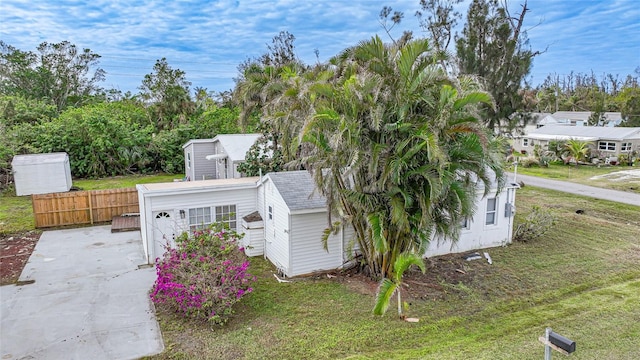 view of side of home with a yard