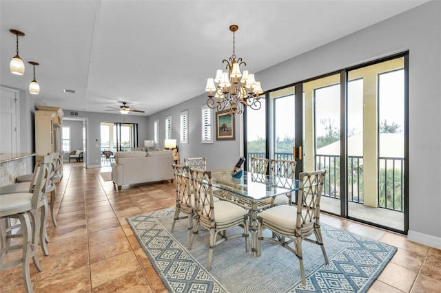 dining area with light tile patterned floors and ceiling fan with notable chandelier