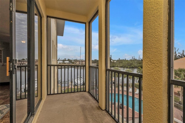 unfurnished sunroom with a water view