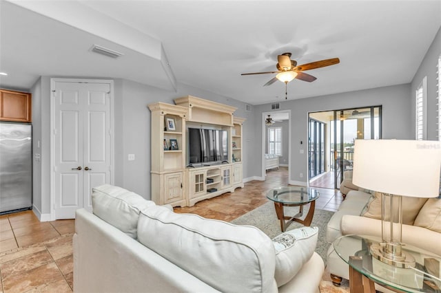 living room featuring ceiling fan and light tile patterned floors