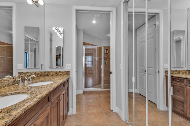 bathroom with tile patterned floors, vanity, and a shower with shower door