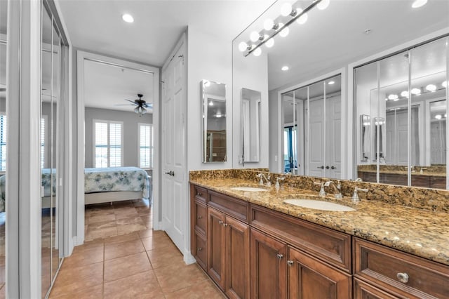 bathroom with ceiling fan, tile patterned flooring, and vanity