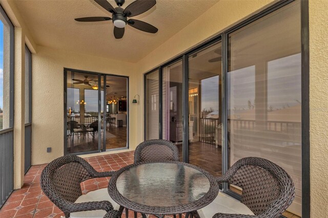 sunroom / solarium featuring ceiling fan