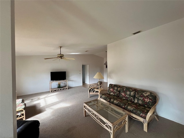 living room with lofted ceiling, ceiling fan, and carpet floors