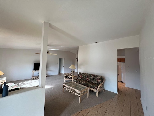 living room featuring vaulted ceiling, ceiling fan, and tile patterned floors