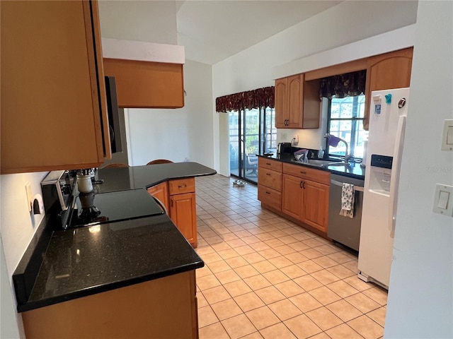 kitchen with stainless steel dishwasher, kitchen peninsula, sink, white refrigerator with ice dispenser, and light tile patterned floors