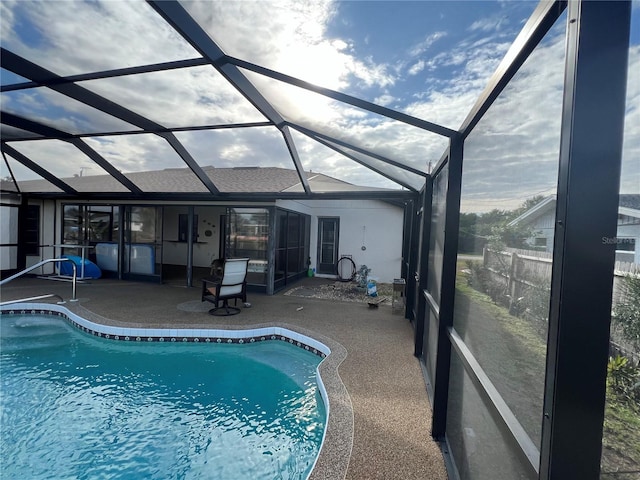 view of swimming pool with a lanai and a patio