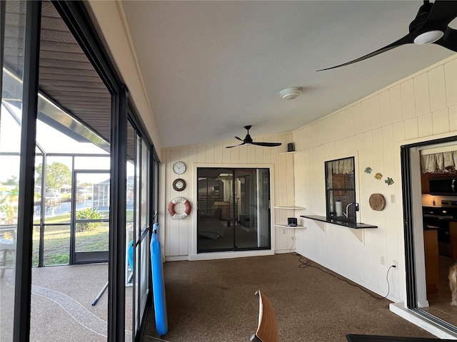 unfurnished sunroom with lofted ceiling and ceiling fan