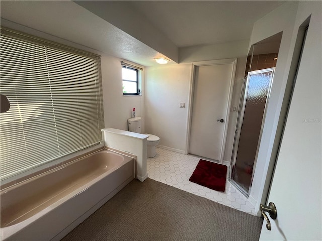 bathroom featuring toilet and separate shower and tub