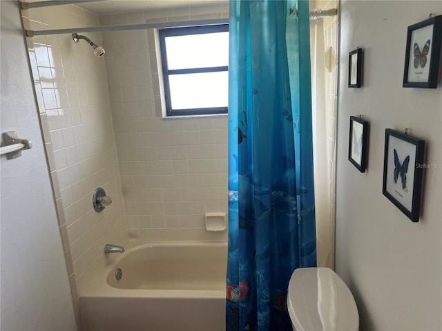 bathroom featuring toilet and shower / tub combo with curtain