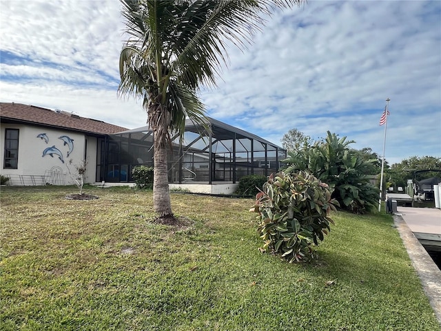 view of yard with glass enclosure