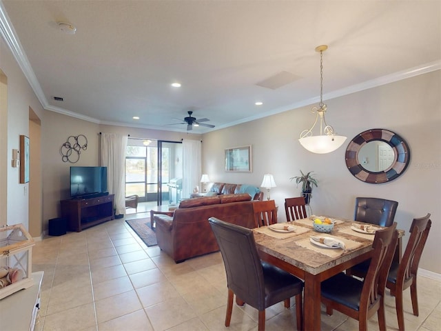 dining space featuring crown molding, light tile patterned floors, and ceiling fan