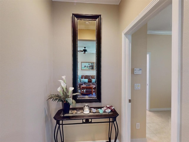 corridor featuring light tile patterned floors and ornamental molding