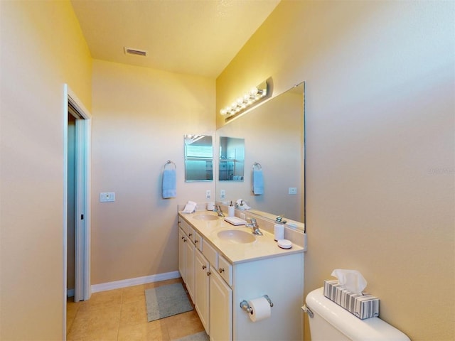 bathroom with tile patterned floors, vanity, and toilet