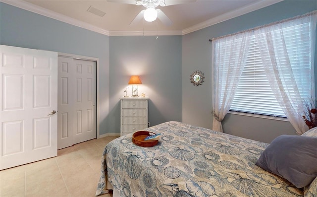 tiled bedroom featuring a closet, ceiling fan, and crown molding