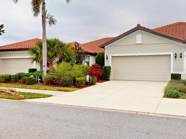 mediterranean / spanish-style home with a garage