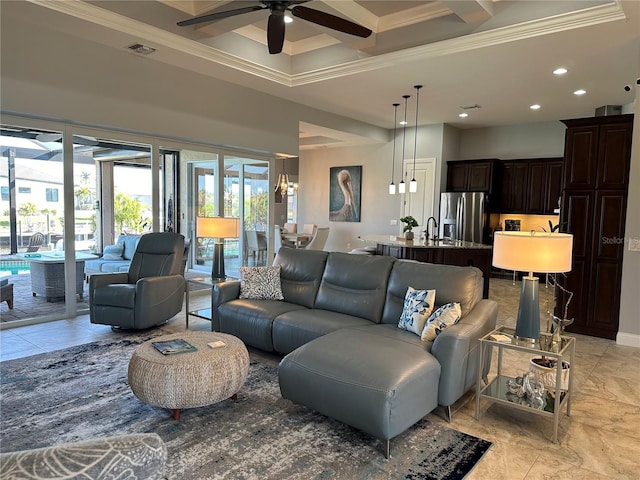 living room with beam ceiling, ceiling fan, crown molding, and a high ceiling