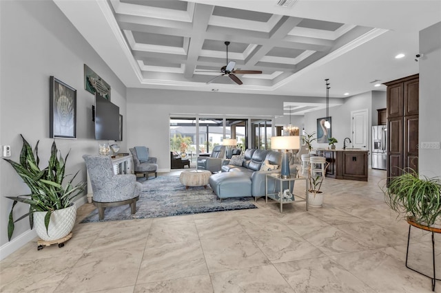 living room with beamed ceiling, sink, coffered ceiling, ceiling fan, and crown molding