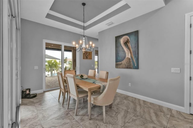 dining space with a raised ceiling and an inviting chandelier